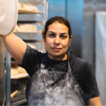 Woman worker in kitchen of bakery, Photo courtesy of ICA.